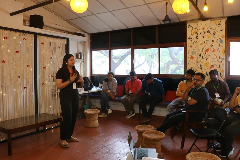 A talk opening the evening under string lights at Circa, Chennai.